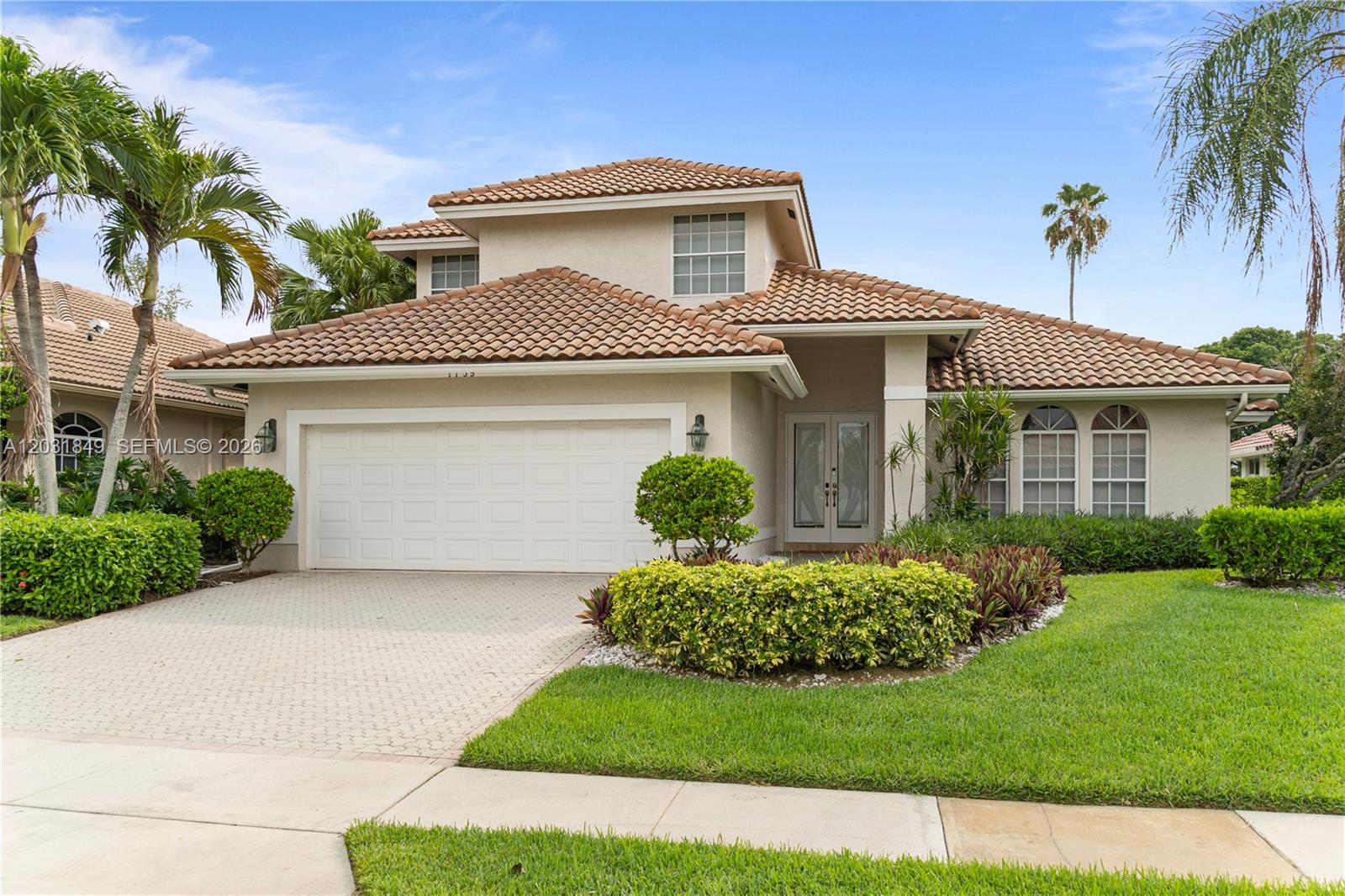 A two-story house with a tile roof, a two-car garage, and a landscaped front yard — 7759 La Corniche Cir, Boca Raton FL 33433, BOCA RATON, FL