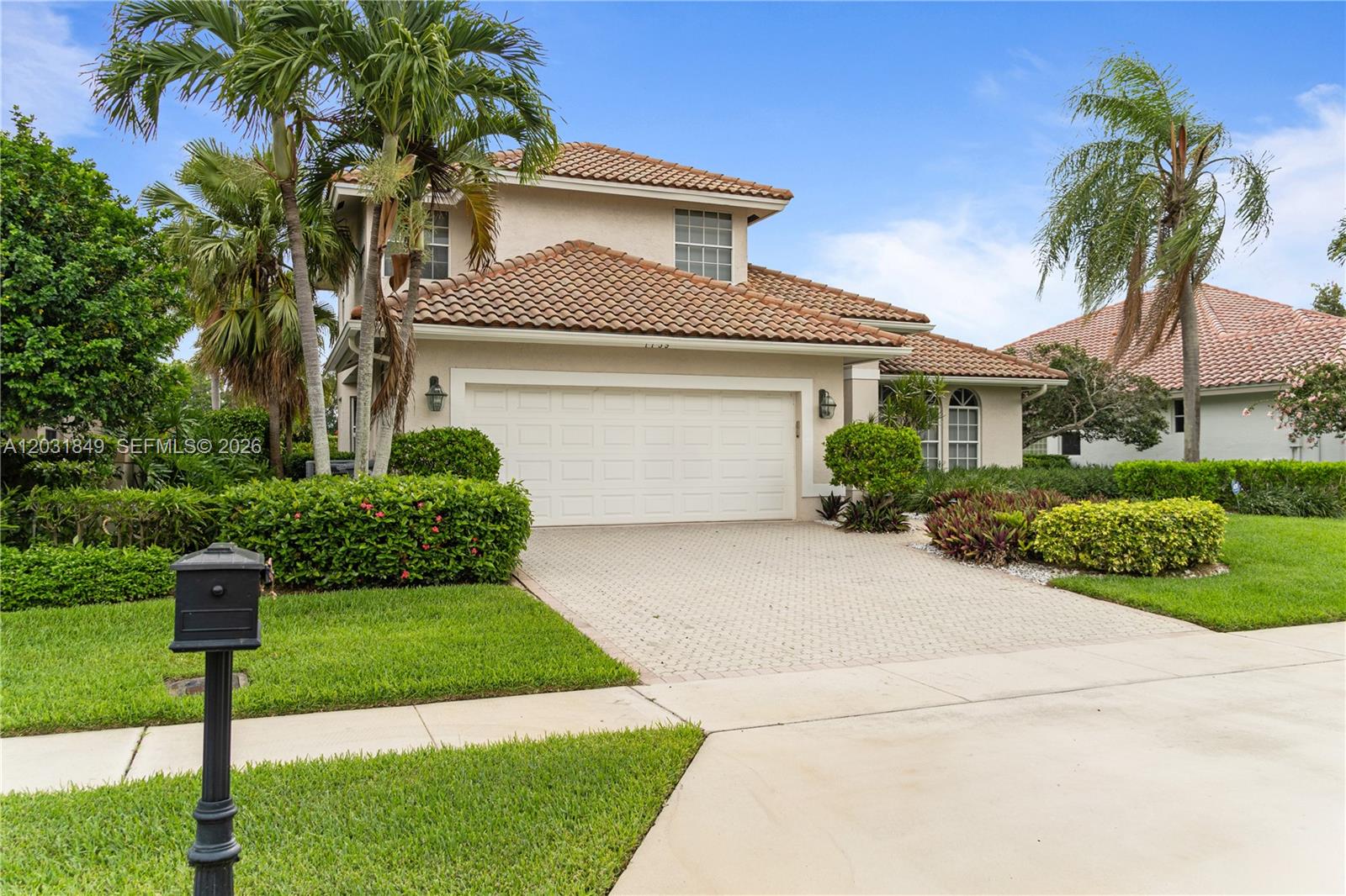 A two-story house with a tiled roof, a paved driveway, and a front lawn — 7759 La Corniche Cir, Boca Raton FL 33433, BOCA RATON, FL