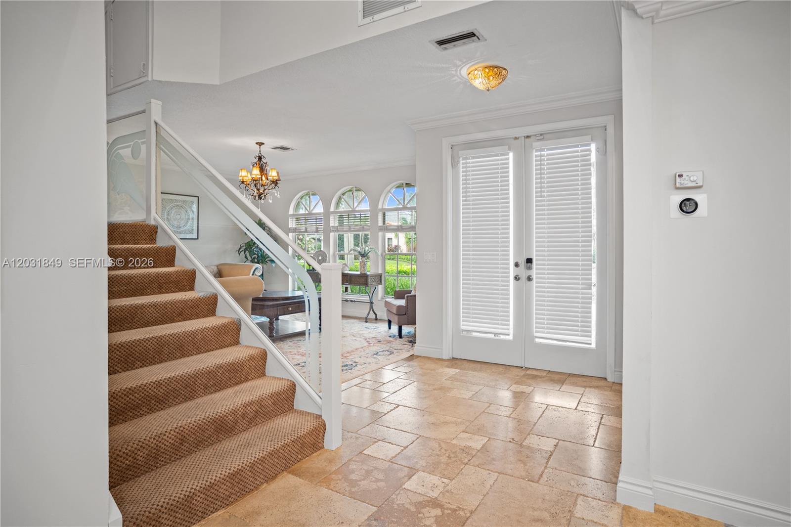 An entryway features a carpeted staircase, tile flooring, and double glass doors with blinds — 7759 La Corniche Cir, Boca Raton FL 33433, BOCA RATON, FL