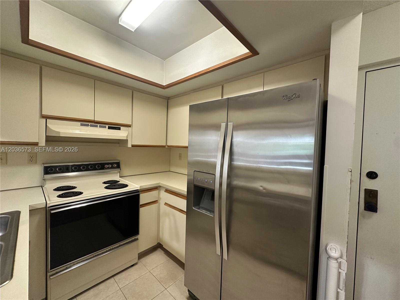 A kitchen features white cabinets, a white electric range, and a stainless steel refrigerator — 8999 SW 123rd Ct # 212, Miami FL 33186, MIAMI, FL