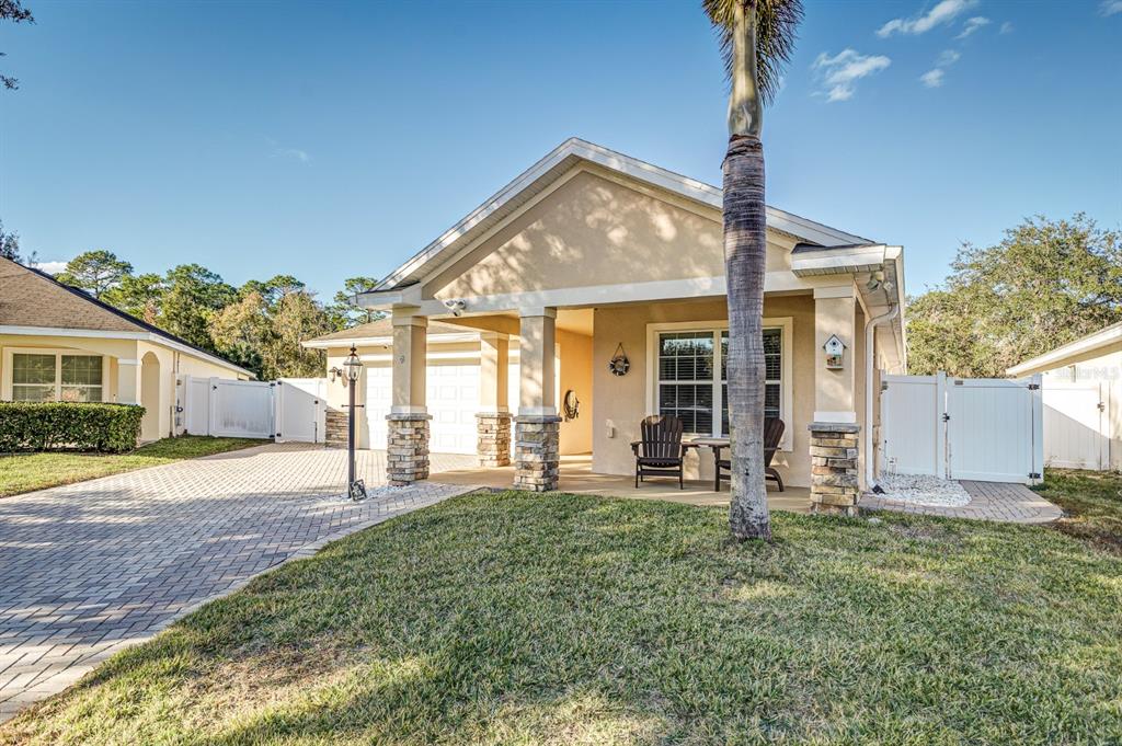 A single-story house with a paved driveway, stone-accented columns, and a covered front porch — 7233 WAKEVIEW DRIVE, DAVENPORT, FL
