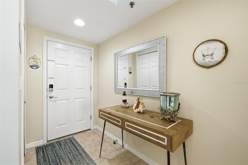 A living and dining room with light blue walls, tile flooring, and coastal decor — 5300 S ATLANTIC AVENUE UNIT 9-401, NEW SMYRNA BEACH, FL