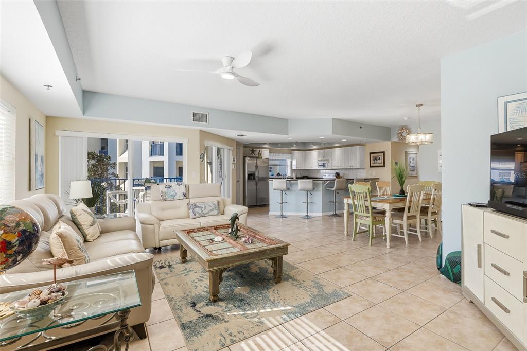 A dining area with a wooden table, light green chairs, and blue walls — 5300 S ATLANTIC AVENUE UNIT 9-401, NEW SMYRNA BEACH, FL