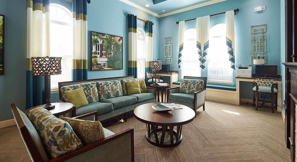 A living room with blue walls, a sofa, two armchairs, a coffee table, and a desk — 4 MAGGIE LANE UNIT Harmony, SARASOTA, FL