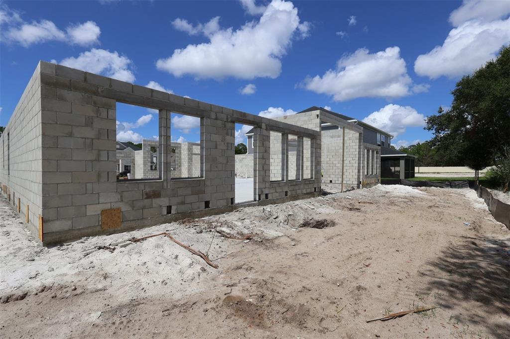 A construction site shows the concrete block walls of a house under development — 2508 HAWKS OVERLOOK PLACE, OVIEDO, FL