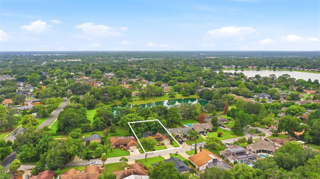 An aerial view shows a single-story house with a white outline on a suburban lot — 207 ATHERSTONE COURT, LONGWOOD, FL