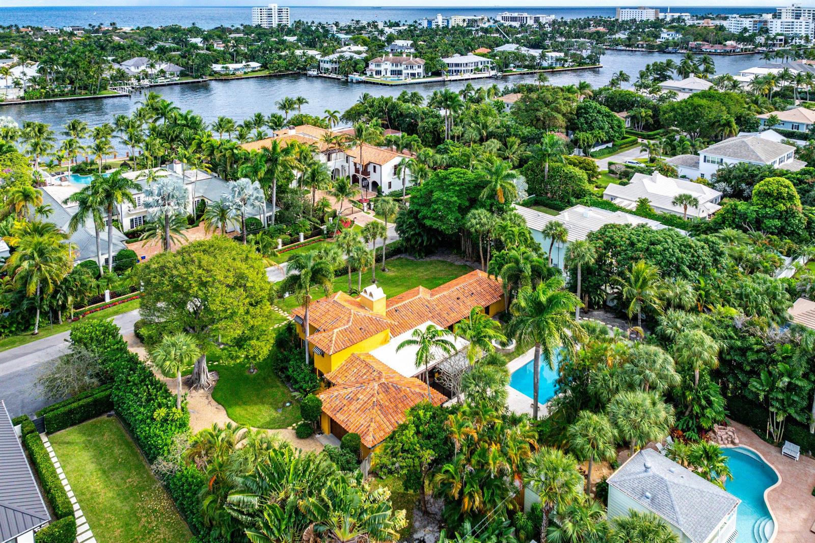 An aerial view shows a yellow house with a tile roof, pool, and lush landscaping — 334 Palm Trail, Delray Beach FL 33483, DELRAY BEACH, FL