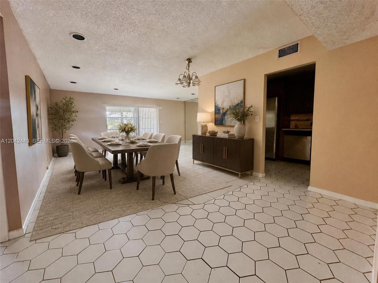 A dining room features a wooden table, upholstered chairs, a sideboard, and hexagonal floor tiles — 3360 Spanish Moss Ter # 206, Lauderhill FL 33319, LAUDERHILL, FL