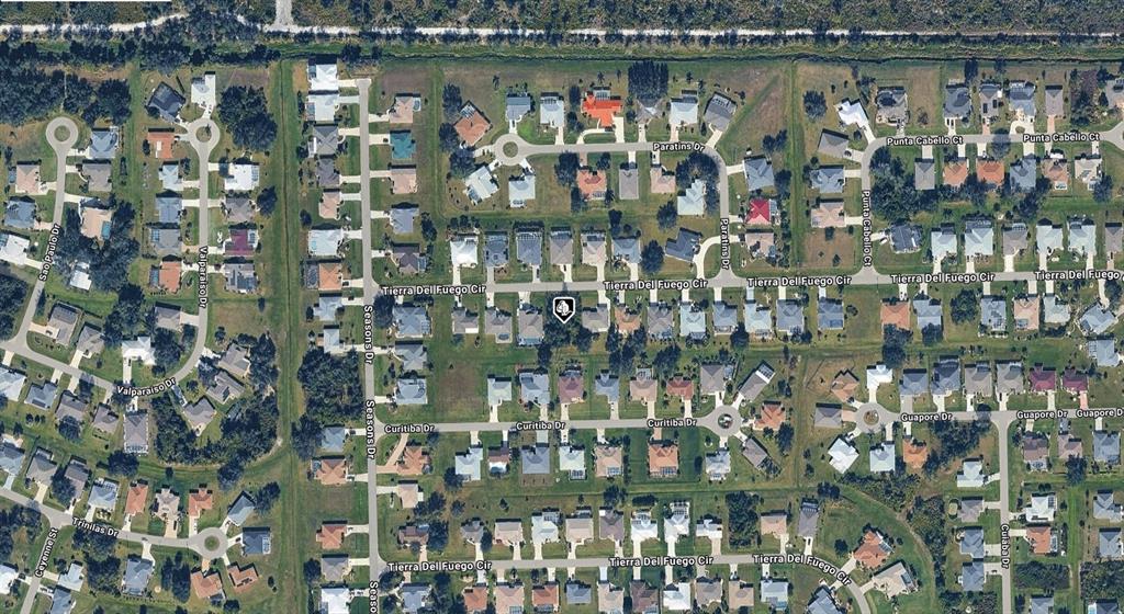 An aerial view of a suburban residential neighborhood featuring houses, streets, and green spaces — 27069 TIERRA DEL FUEGO CIRCLE, PUNTA GORDA, FL