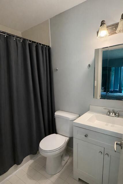 A bathroom features a dark shower curtain, a white toilet, and a white vanity cabinet — 416 Meadows Circle, Boynton Beach FL 33436, BOYNTON BEACH, FL