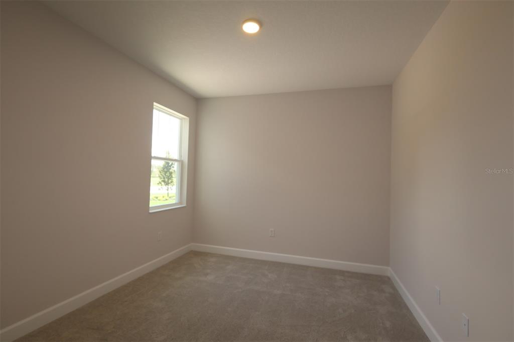 A bathroom features a freestanding tub, a double vanity with a mirror, and tiled flooring — 3795 WOLVES CREEK PLACE, APOPKA, FL