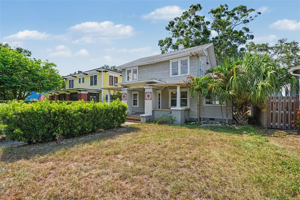 A two-story gray house with a front porch stands next to a yellow house — 5441 1ST AVENUE N, ST PETERSBURG, FL