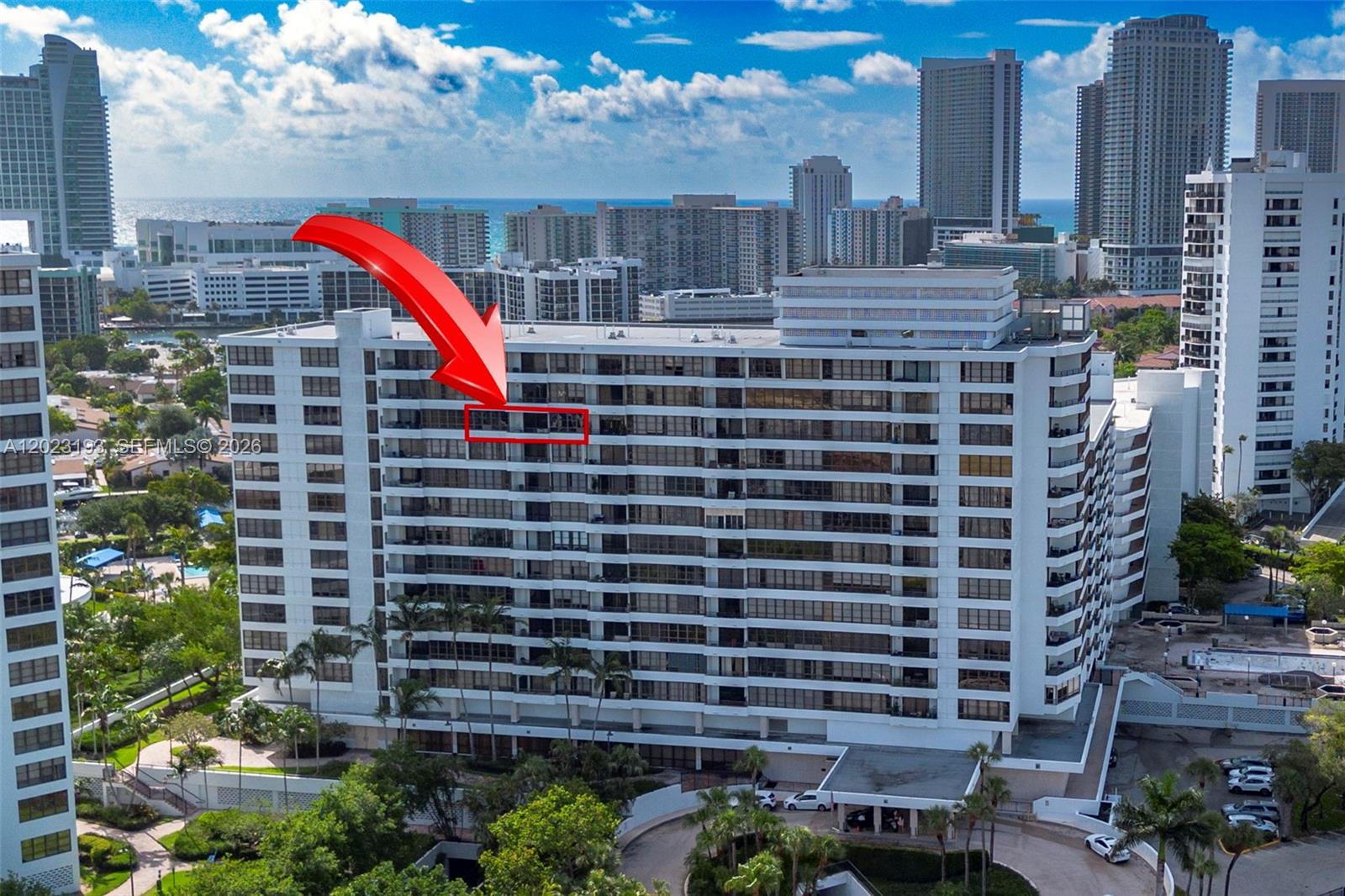 An exterior view of a high-rise apartment building with a red arrow highlighting a balcony — 500 Three Islands Blvd # 1008, Hallandale Beach FL 33009, HALLANDALE BEACH, FL