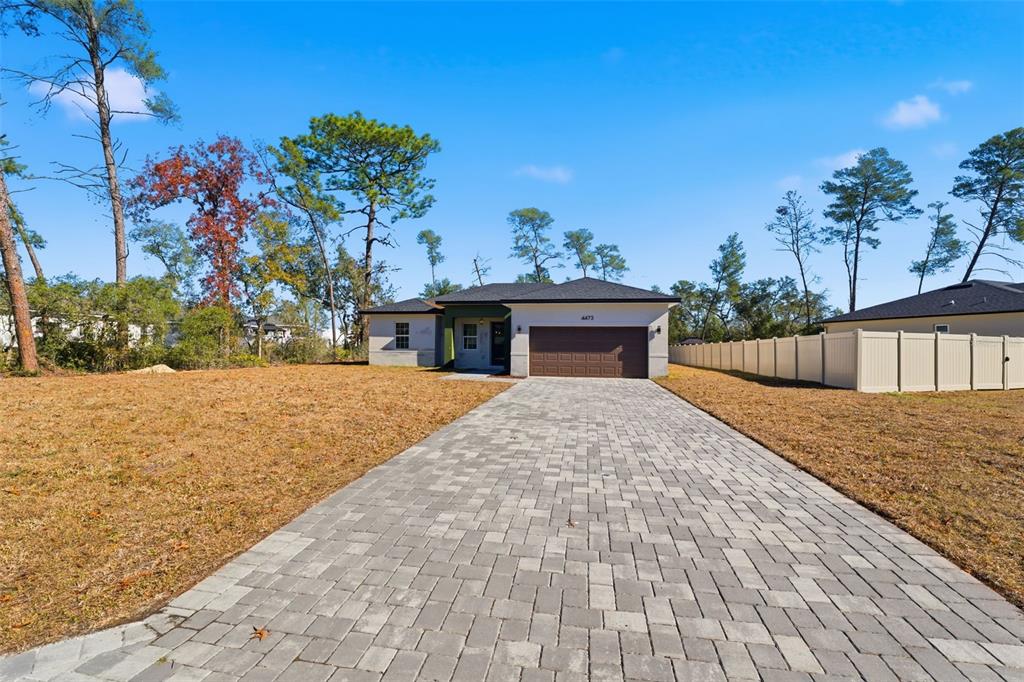 A single-story house with a paved driveway and a two-car garage sits on a lot — 4473 SW 168TH LANE, OCALA, FL
