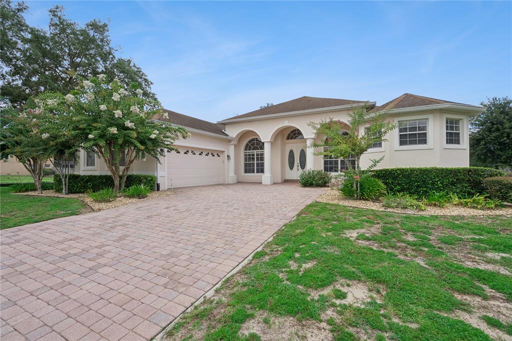 A single-story house with a paved driveway, arched entryway, and a two-car garage — 3700 DUNOON COURT, APOPKA, FL