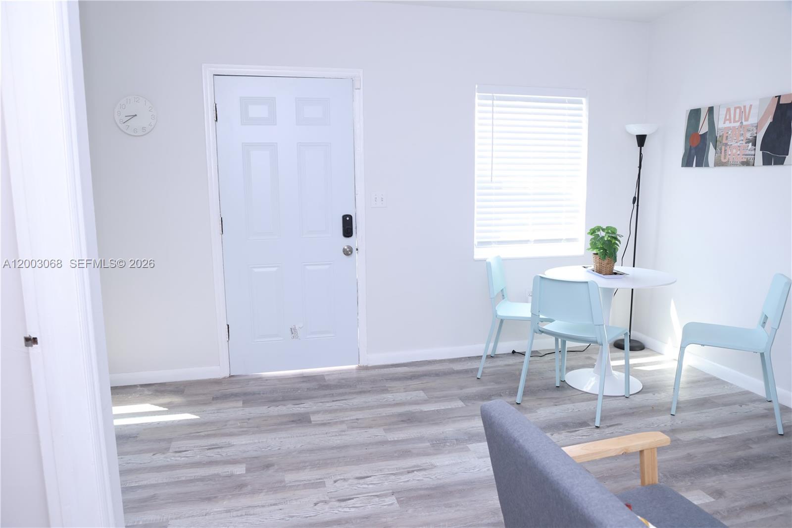 A dining area features a white table, three light blue chairs, and light wood-look flooring — 1109 SW 37th Ave # 1115, Miami FL 33135, MIAMI, FL