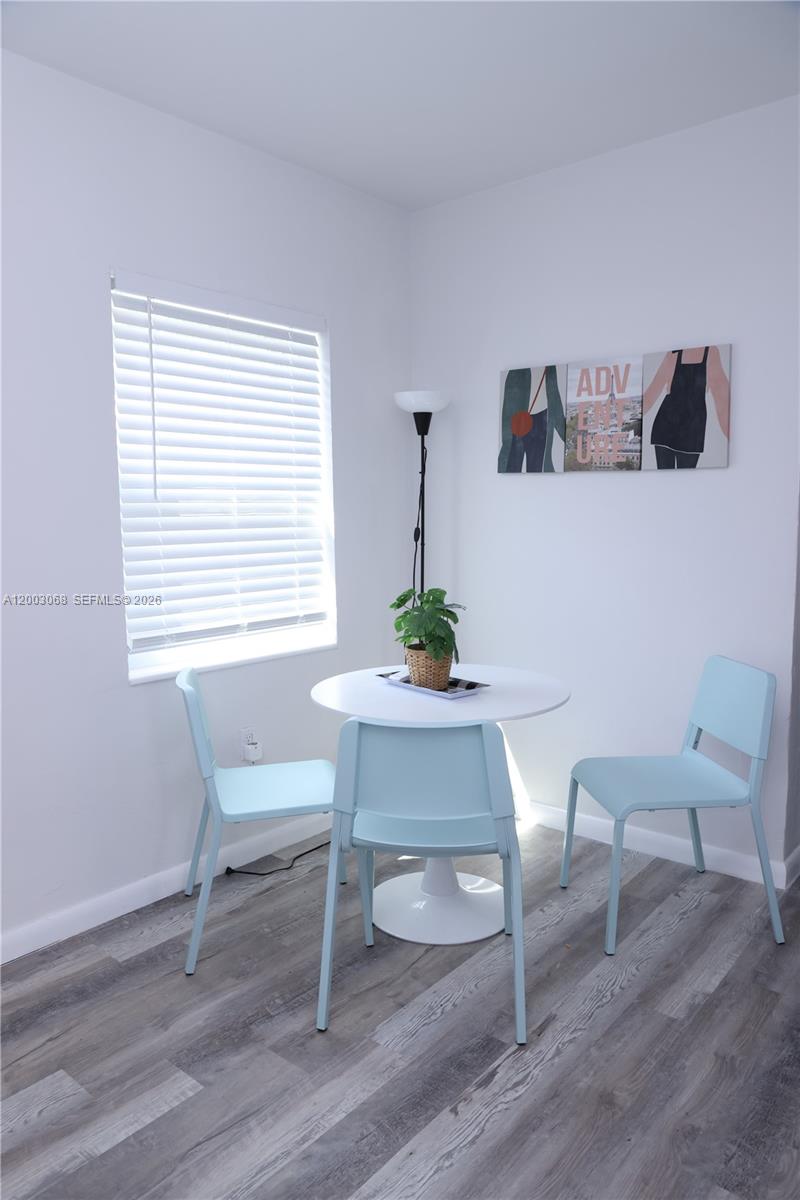 A small dining area features a white table, three light blue chairs, and a floor lamp — 1109 SW 37th Ave # 1115, Miami FL 33135, MIAMI, FL