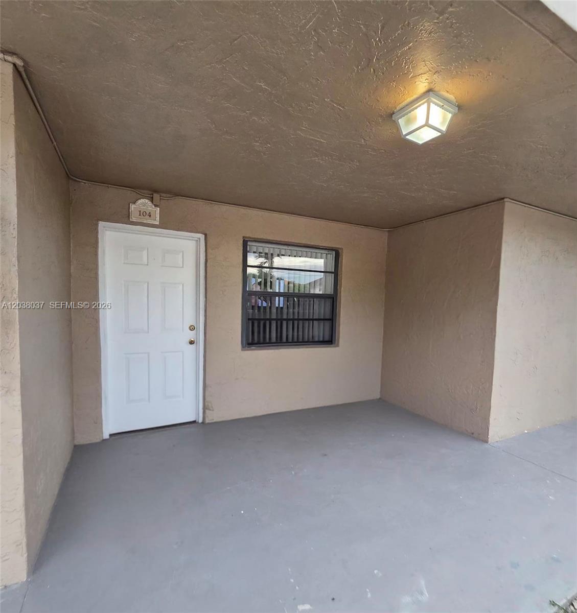 The exterior view shows a beige building entrance with a white door labeled 104 — 2560 W 60th St # 104, Hialeah FL 33016, HIALEAH, FL