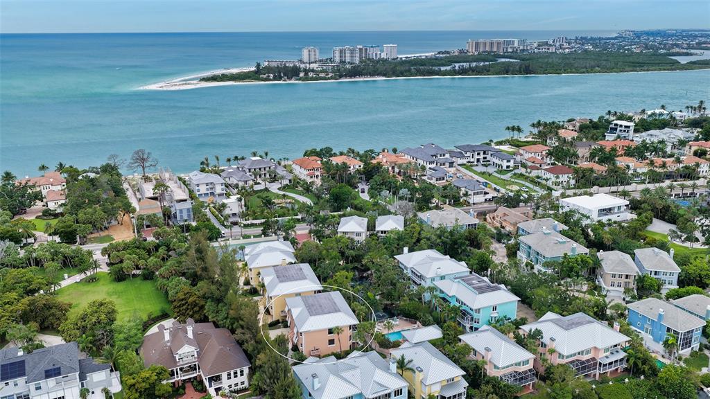 An aerial view shows a residential neighborhood near the coast with a circled multi-story house — 3942 HAMILTON CLUB CIRCLE UNIT 13, SARASOTA, FL