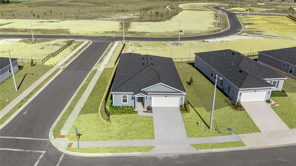 An aerial view shows a single-story house with a dark roof and a concrete driveway — 8814 SW 69TH TERRACE, OCALA, FL