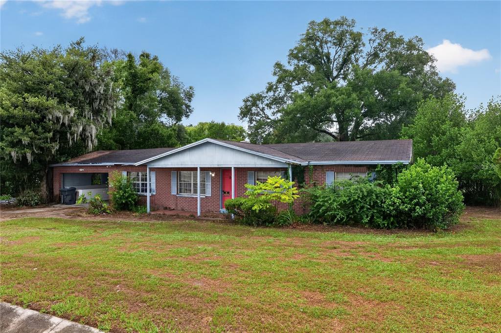 A single-story brick house with a covered porch and an attached carport — 4315 E COUNTY ROAD 540A, LAKELAND, FL