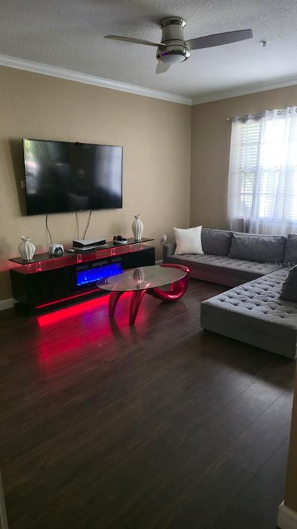 A living room features a gray sectional sofa, a glass coffee table, and a media console — 2600 ROBERT TRENT JONES DRIVE UNIT 914, ORLANDO, FL