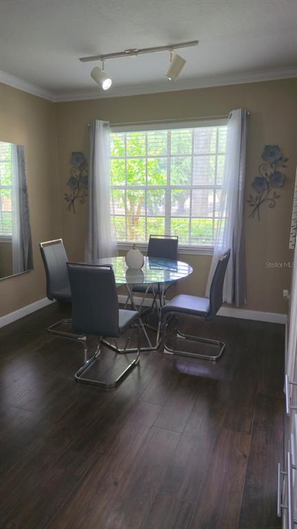 A living room features a grey sectional sofa, a glass coffee table, and dark flooring — 2600 ROBERT TRENT JONES DRIVE UNIT 914, ORLANDO, FL