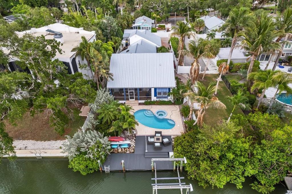 An aerial view of a waterfront house with a swimming pool, deck, and boat dock — 115 EDMONDSON AVENUE, SARASOTA, FL
