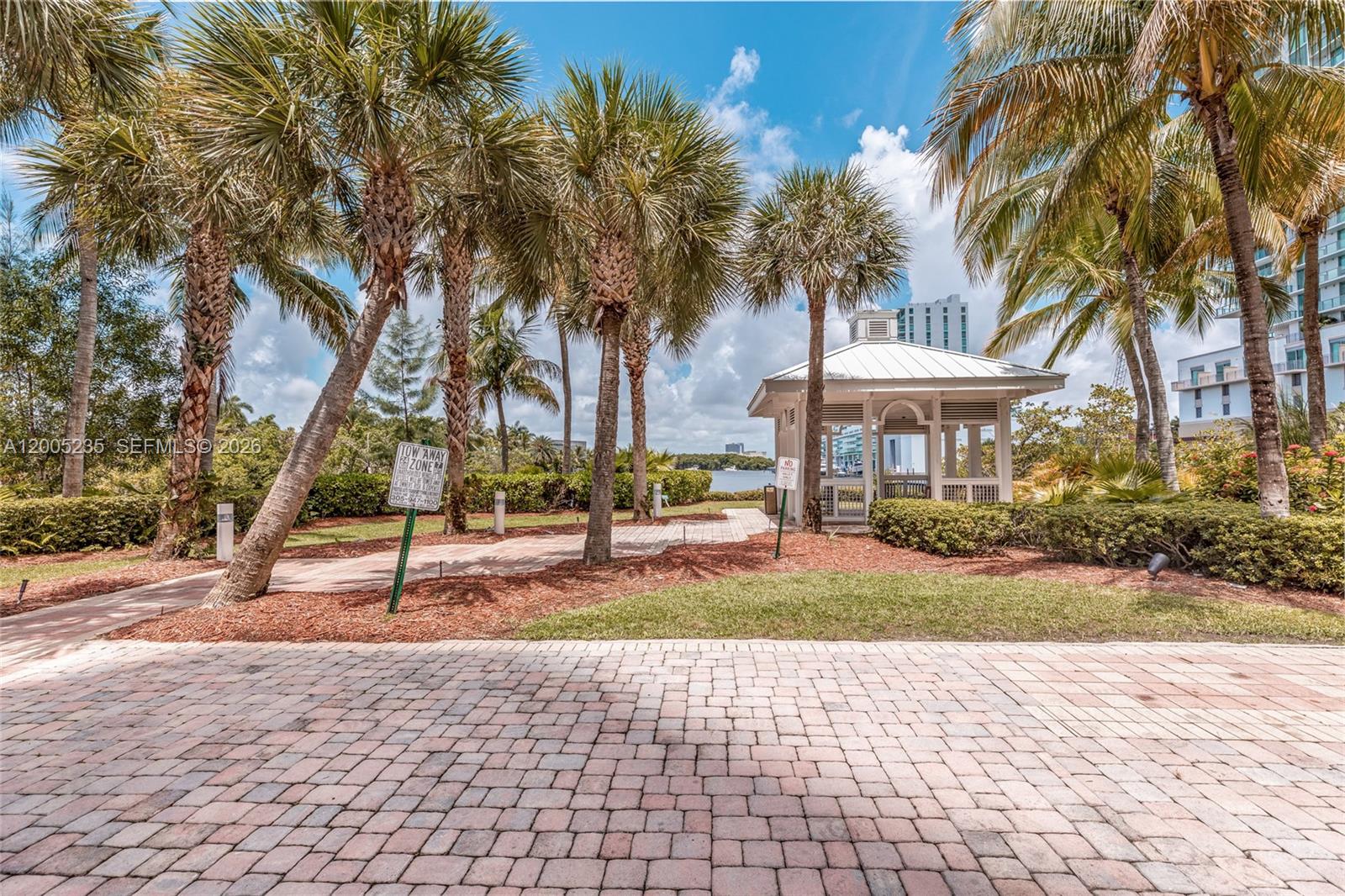 A paved walkway leads to a white gazebo surrounded by palm trees and landscaping — 16500 Collins Ave # 655, Sunny Isles Beach FL 33160, SUNNY ISLES BEACH, FL