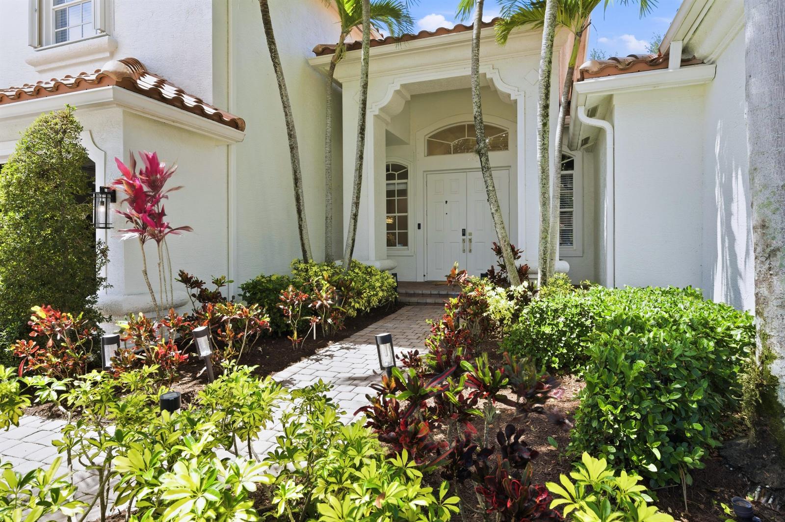 A two-story white stucco house with a tile roof, palm trees, and a landscaped lawn — 7153 Via Abruzzi, Lake Worth FL 33467, LAKE WORTH, FL