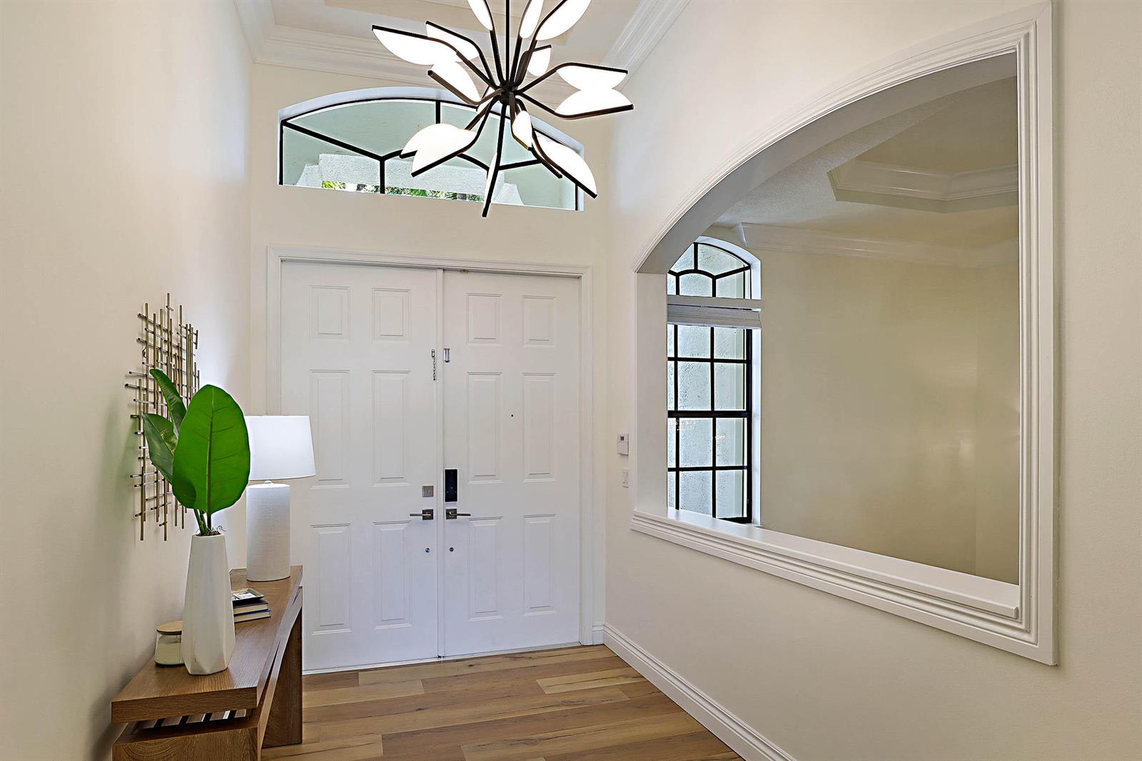 A living room features a grand piano, a fireplace, and a view of the backyard — 7153 Via Abruzzi, Lake Worth FL 33467, LAKE WORTH, FL