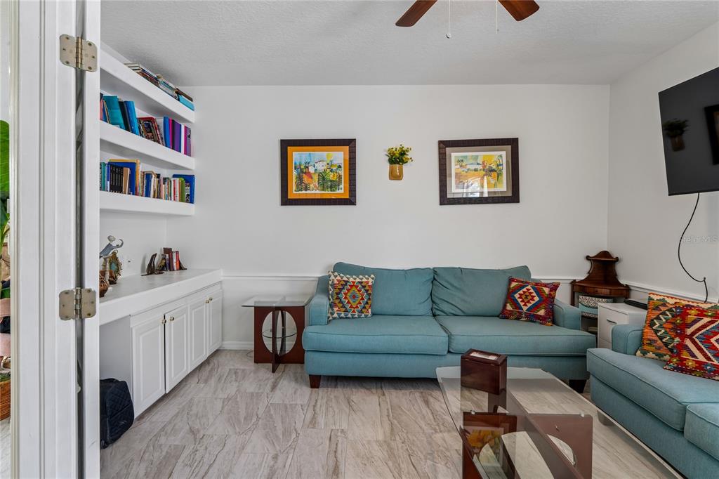 A bathroom features a vanity with a white sink, a toilet, and a glass-enclosed shower — 14465 MIDDLE FAIRWAY DRIVE, SPRING HILL,, FL