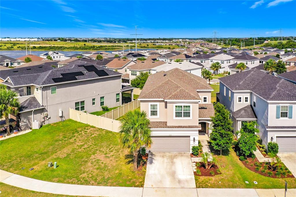 An aerial view of a two-story suburban house with a tan exterior and gray roof — 2854 HIGH POINTE STREET, CLERMONT, FL