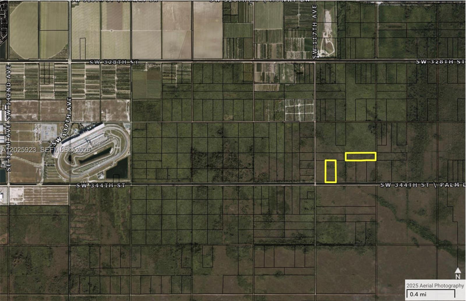 This is an aerial map showing two highlighted rectangular land parcels near a racetrack — 334th St, Unincorporated Dade County FL 33035, UNINCORPORATED DADE COUNTY, FL