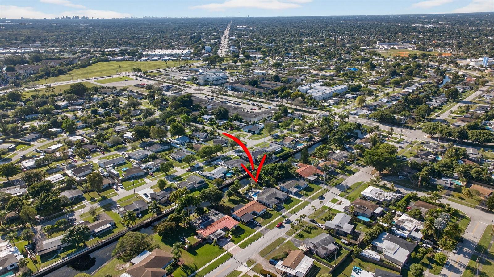 An aerial view shows a residential neighborhood with a red arrow pointing to a house — 1530 W River Drive, Margate FL 33063, MARGATE, FL