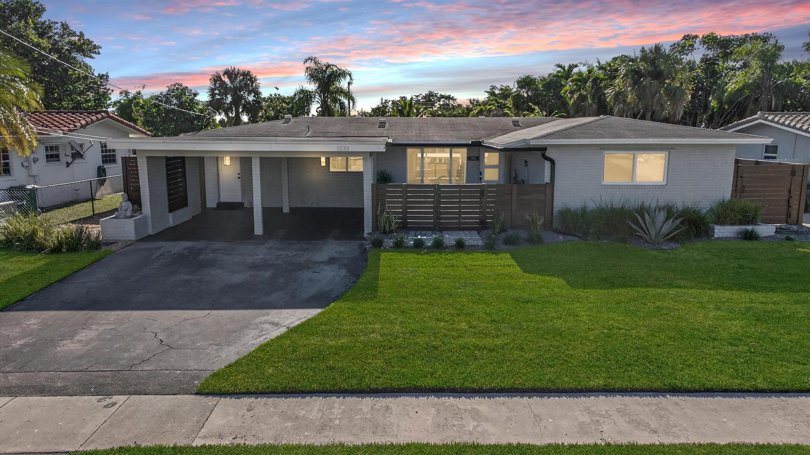 A single-story house features a gray brick exterior, a carport, and a front lawn — 1530 W River Drive, Margate FL 33063, MARGATE, FL