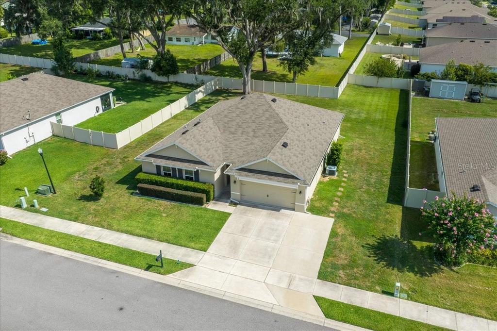 An aerial view shows a single-story house with a tan exterior and a gray roof — 5025 NE 15TH PLACE, OCALA, FL