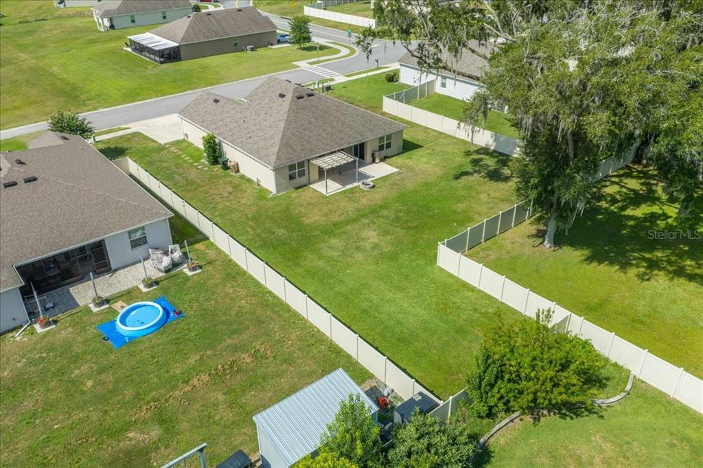 An aerial view shows two suburban houses with fenced backyards and a small pool — 5025 NE 15TH PLACE, OCALA, FL