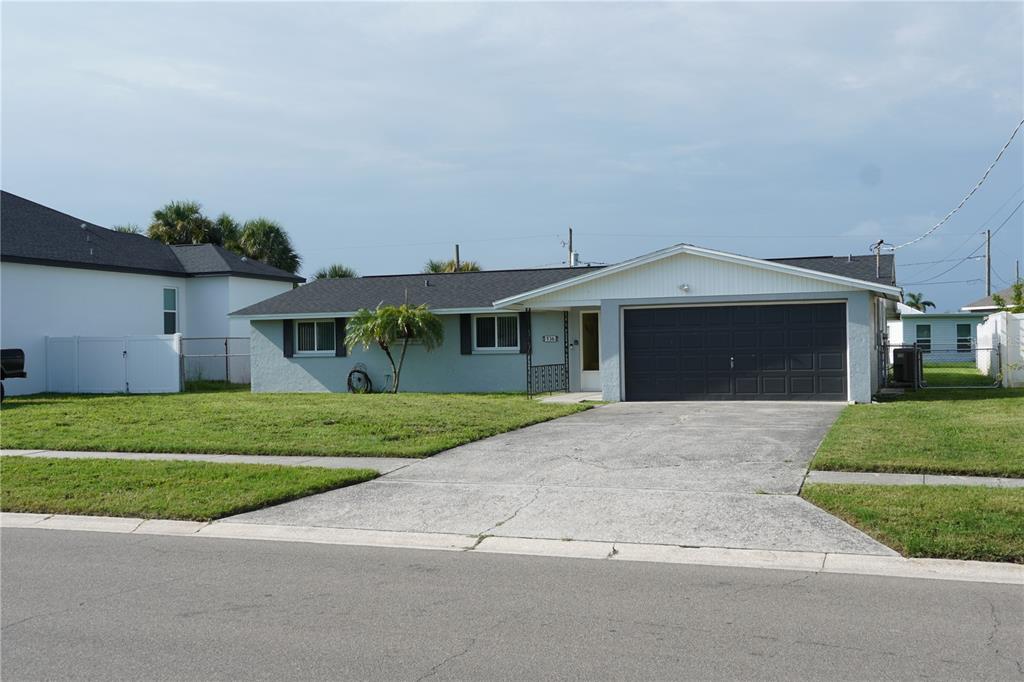 A single-story house with a light blue exterior, dark roof, and an attached two-car garage — 536 FLAMINGO DRIVE, APOLLO BEACH, FL