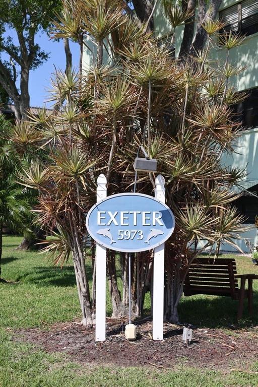 A blue oval sign labeled Exeter 5973 stands in front of a large, spiky plant — 5973 TERRACE PARK DRIVE N UNIT 311, ST PETERSBURG, FL