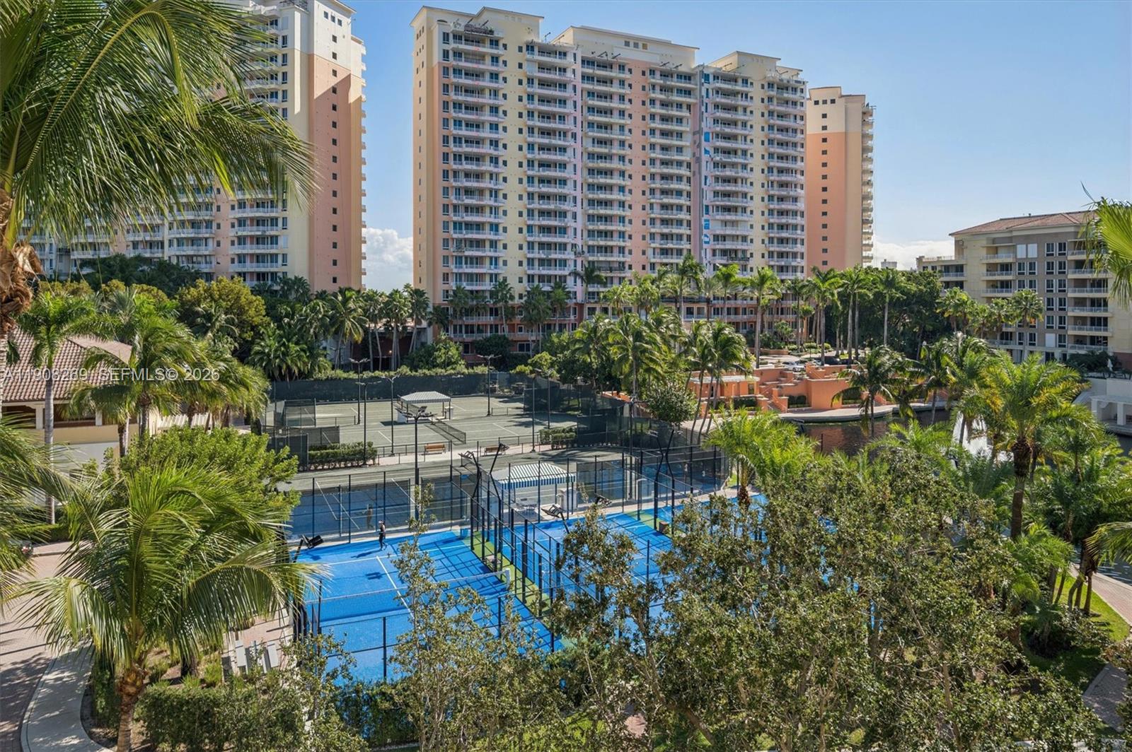 An elevated view of blue pickleball courts, tennis courts, and tall residential buildings — 717 Crandon Blvd # 507, Key Biscayne FL 33149, KEY BISCAYNE, FL