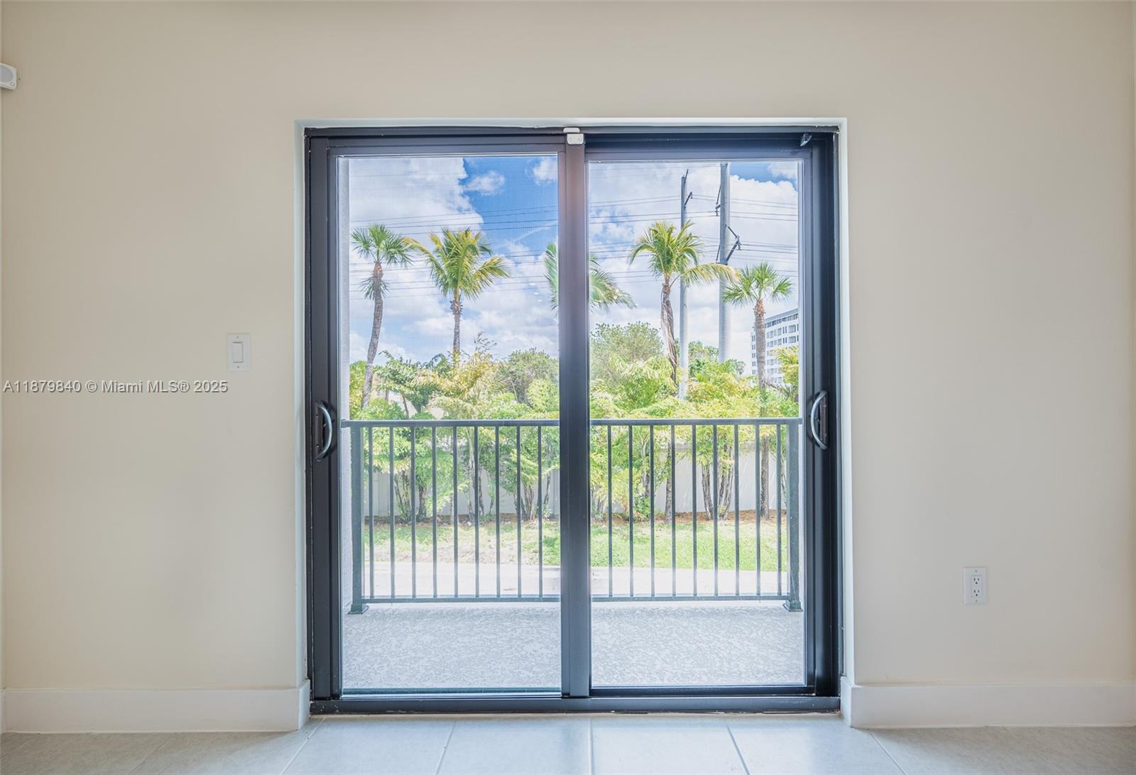 A sliding glass door opens to a balcony with a view of palm trees — 8001 NW 41st St # 208, Doral FL 33166, DORAL, FL