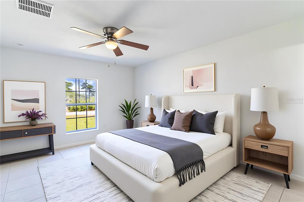 A bedroom features a bed with a neutral headboard, two nightstands, and a ceiling fan — 1411 BITTERSWEET STREET, LAKE PLACID, FL