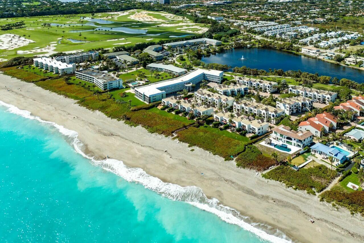 Aerial view of a beachfront resort complex with a golf course and a lake nearby — 170 Celestial Way # 2, Juno Beach FL 33408, JUNO BEACH, FL