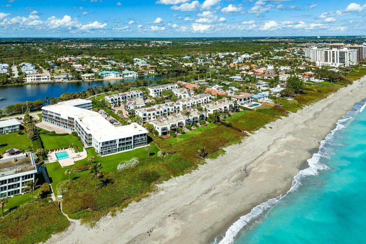 An aerial view shows a beachfront condominium complex with a pool and surrounding residential area — 170 Celestial Way # 2, Juno Beach FL 33408, JUNO BEACH, FL