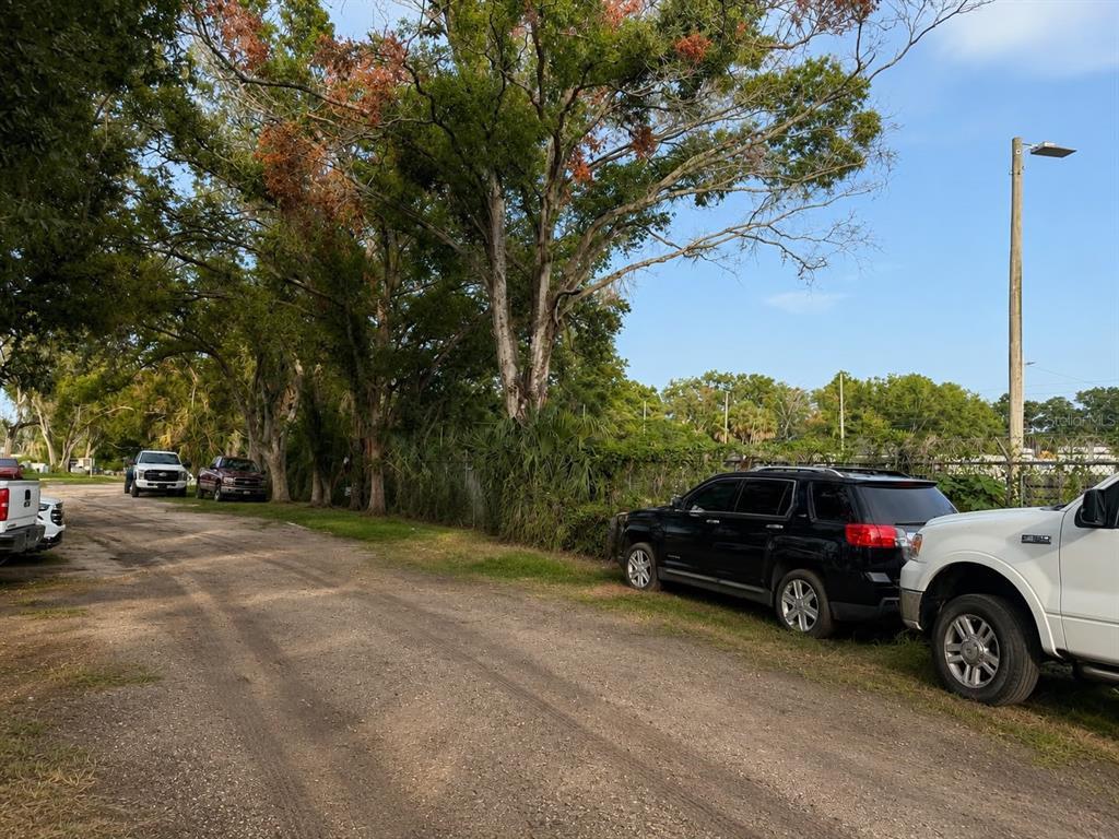 A dirt road runs alongside a line of trees and parked vehicles — 2504 S 54TH STREET, TAMPA, FL