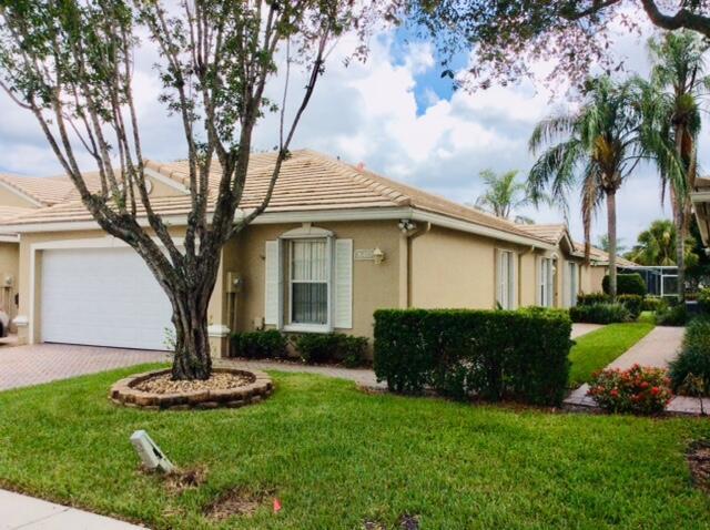 A single-story house with a tan stucco exterior, a tile roof, and a two-car garage — 8410 Cargill Point, West Palm Beach FL 33411, WEST PALM BEACH, FL