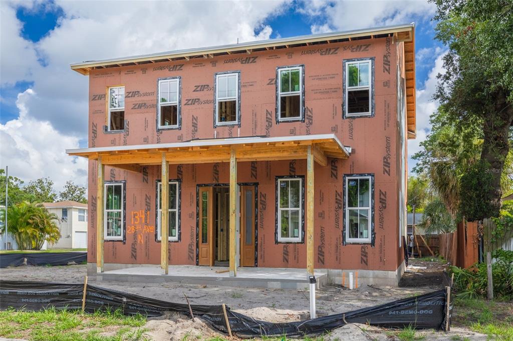 A two-story house under construction features ZIP System sheathing, installed windows, and a front porch — 1341 28TH AVENUE N, ST PETERSBURG, FL