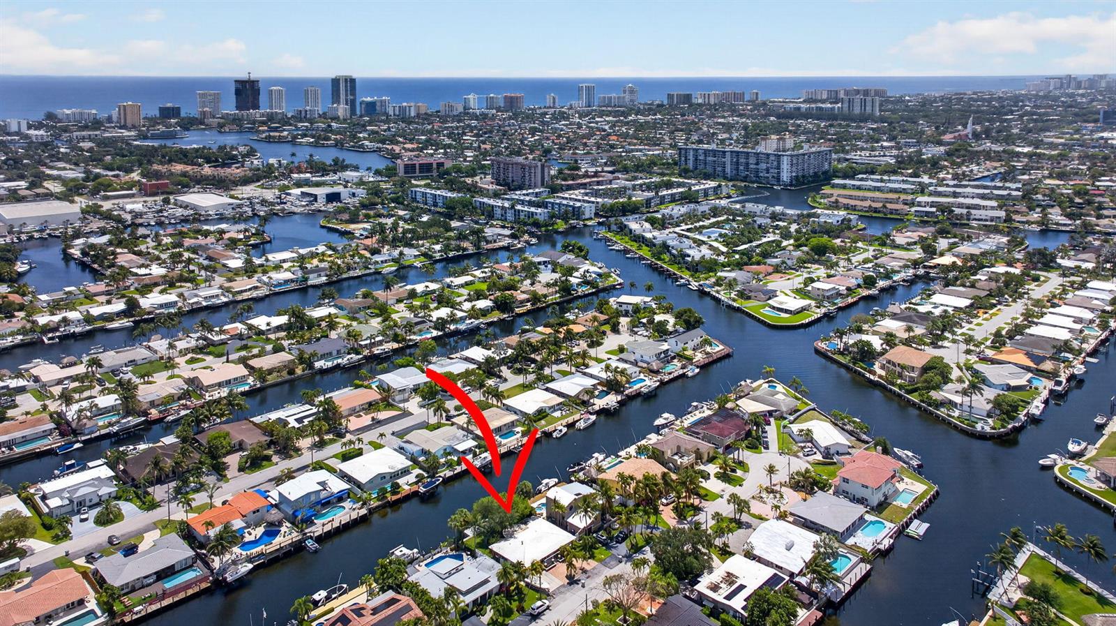 An aerial view of a waterfront neighborhood with a red arrow pointing to a house — 420 SE 14th Avenue, Pompano Beach FL 33060, POMPANO BEACH, FL