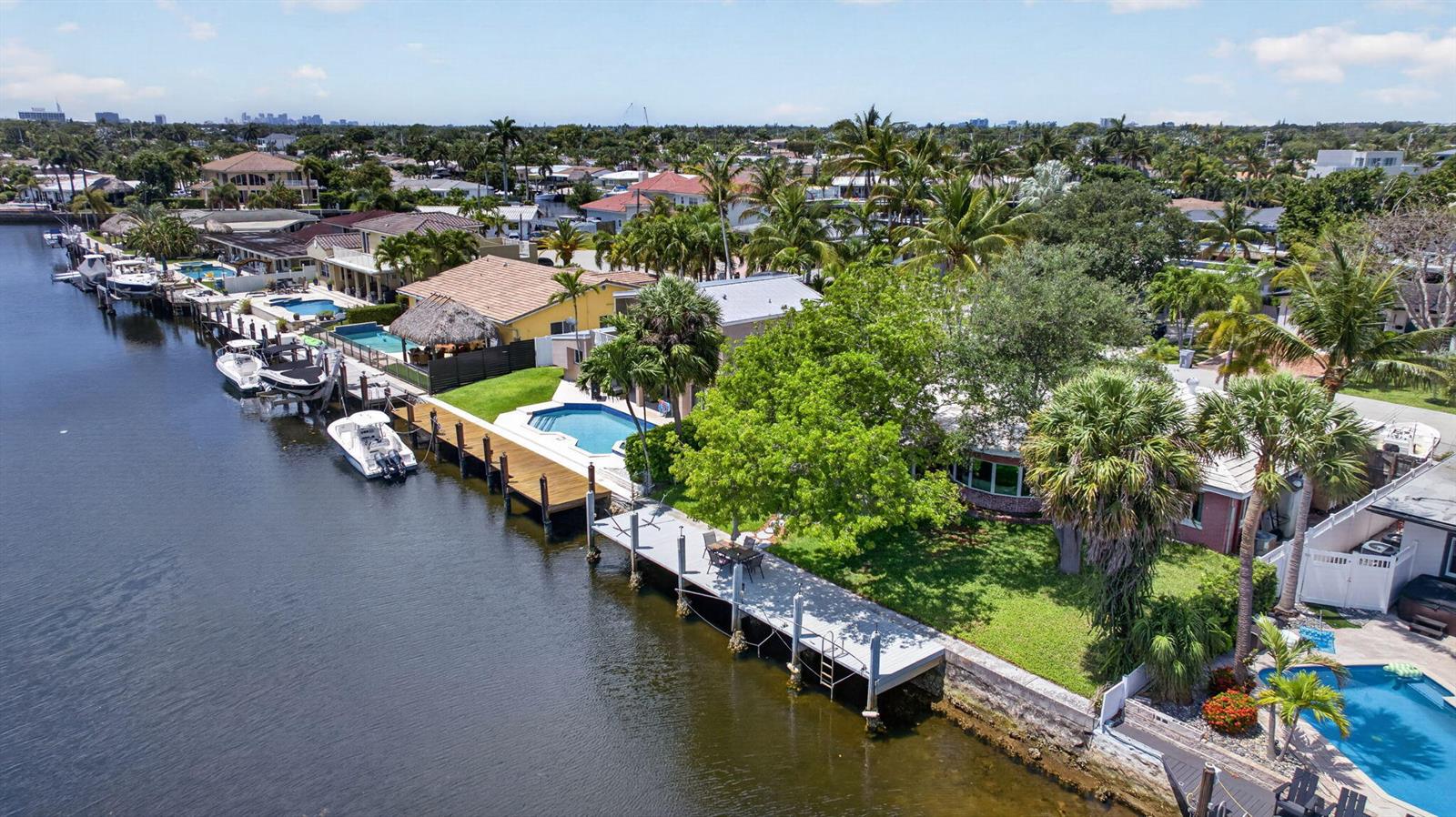 An aerial view shows waterfront houses with private docks, swimming pools, and lush tropical landscaping — 420 SE 14th Avenue, Pompano Beach FL 33060, POMPANO BEACH, FL